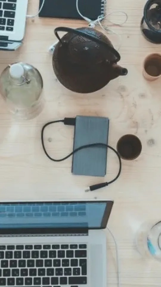 A bunch of laptops on a table from above
